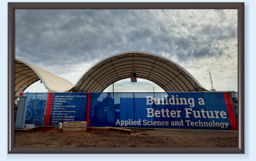 A large outdoor canopy with a sign reading 'Building a Better Future'.