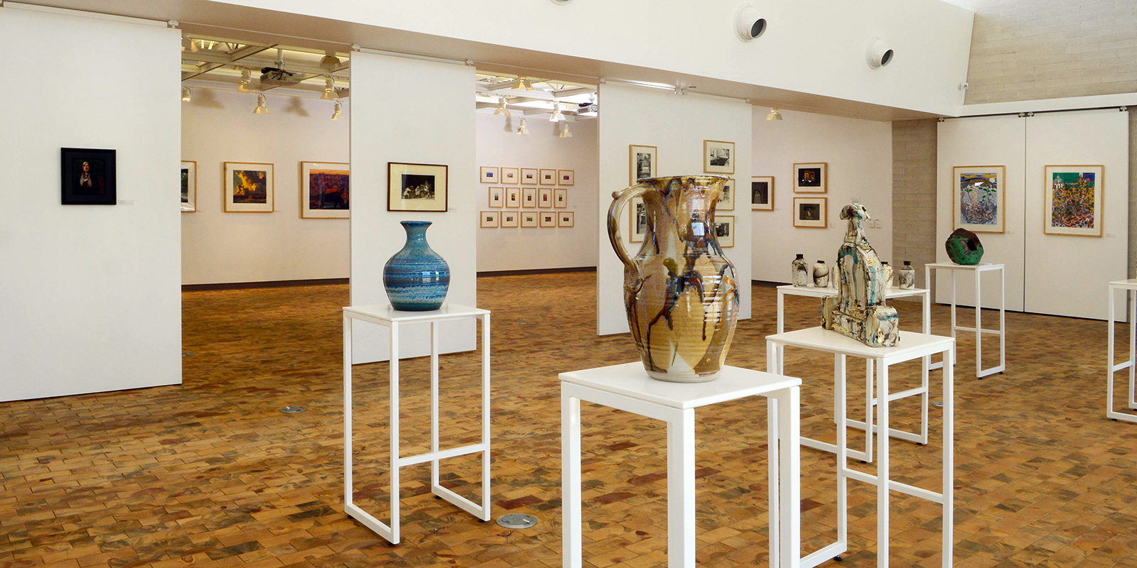 Pots and urns on stands in the gallery.