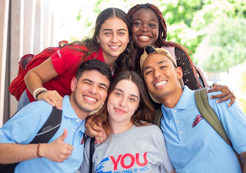 Five students smiling at the camera