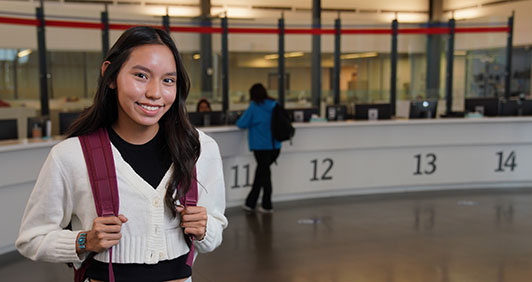 A female student posing in the Enrollment Center