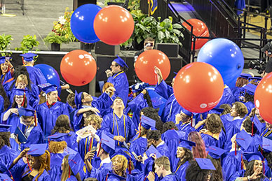 Graduates celebrating as balloons drop