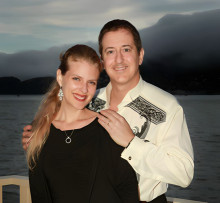 Kristin and Christopher Caliendo pictured with a lake and mountains in the background