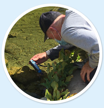 Individual taking water samples