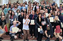 A large group of students holding certificates