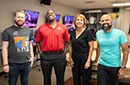 Four people smiling at the camera