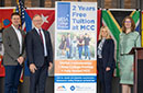 Officials pose with a banner for the Mesa College Promise program