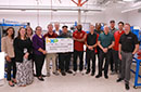 Officials pose while holding a large check from NXP Semiconductors