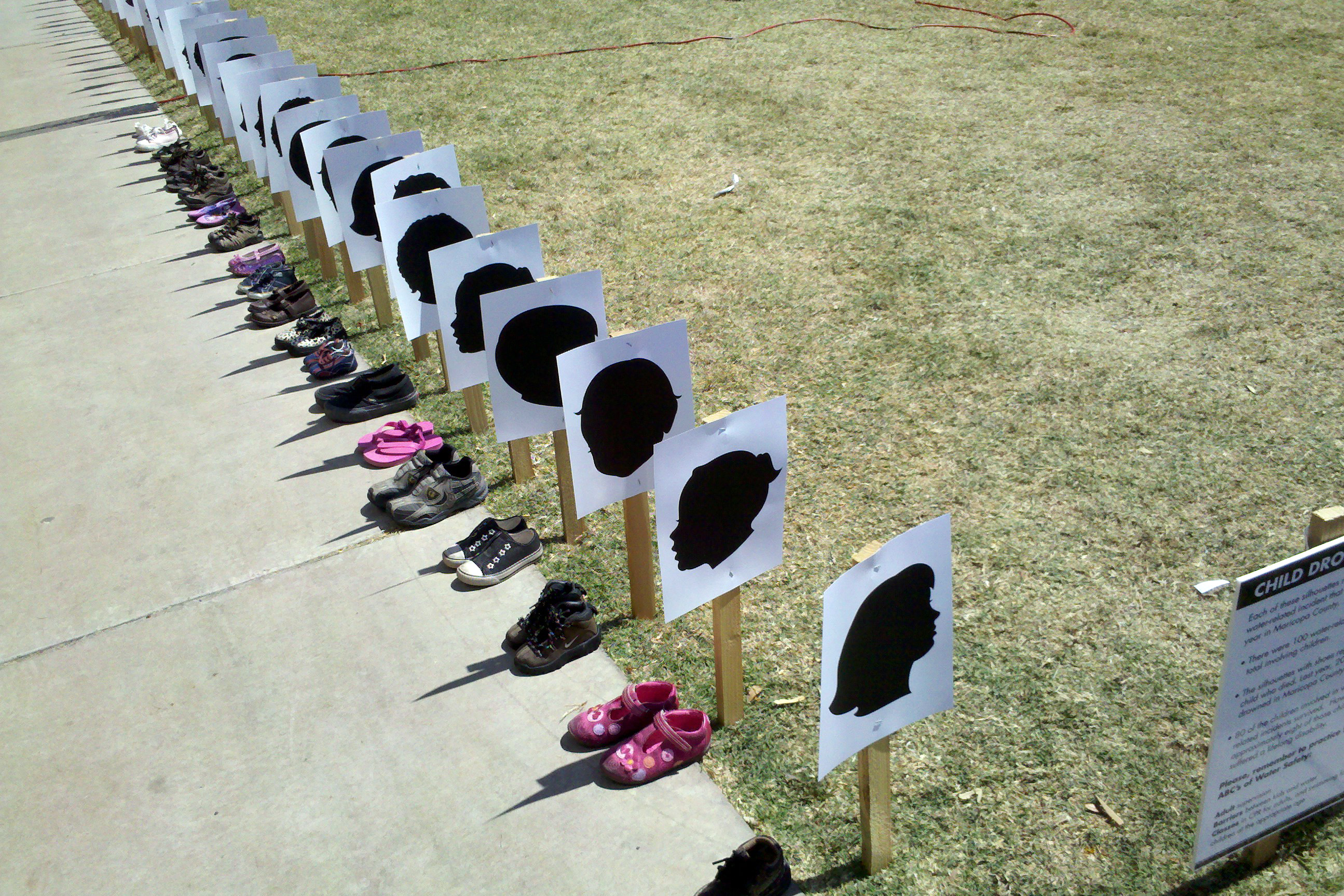 Highlighting the importance of prevention, child drowning deaths are depicted by pairs of childrens shoes