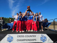 Team with coaches holding the trophy